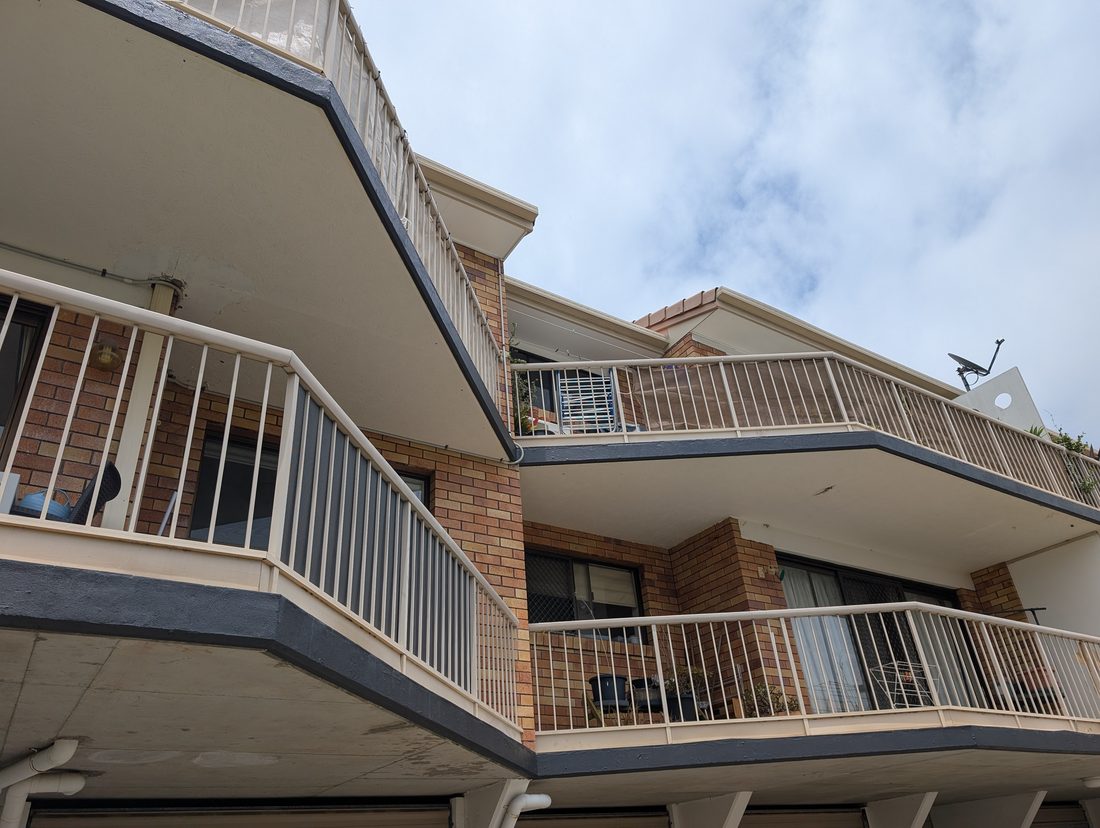 The same apartment balcony fronts and trim repainted clean and crisp