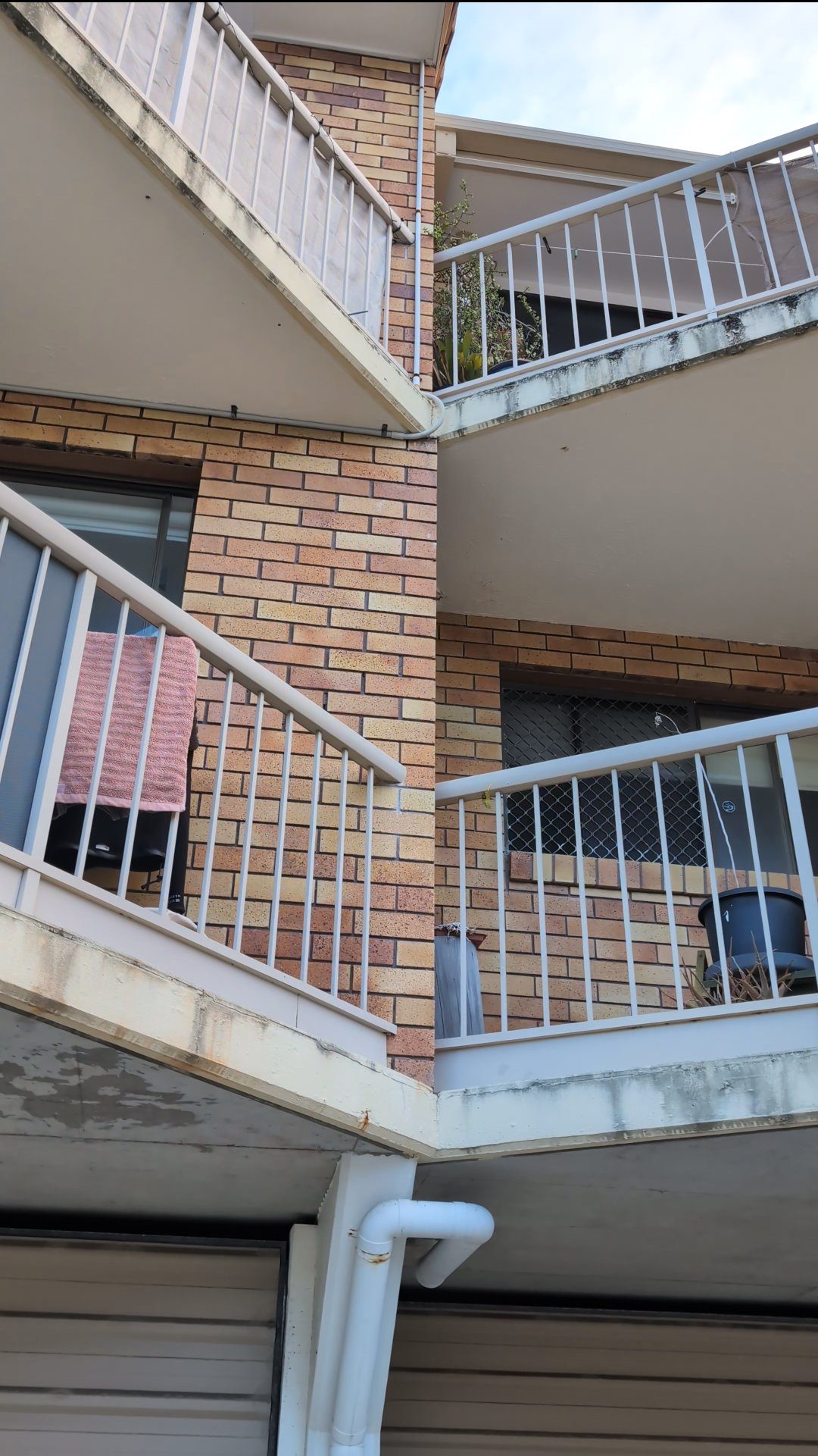 Beachside apartment balconies stained with salt and mould before repainting