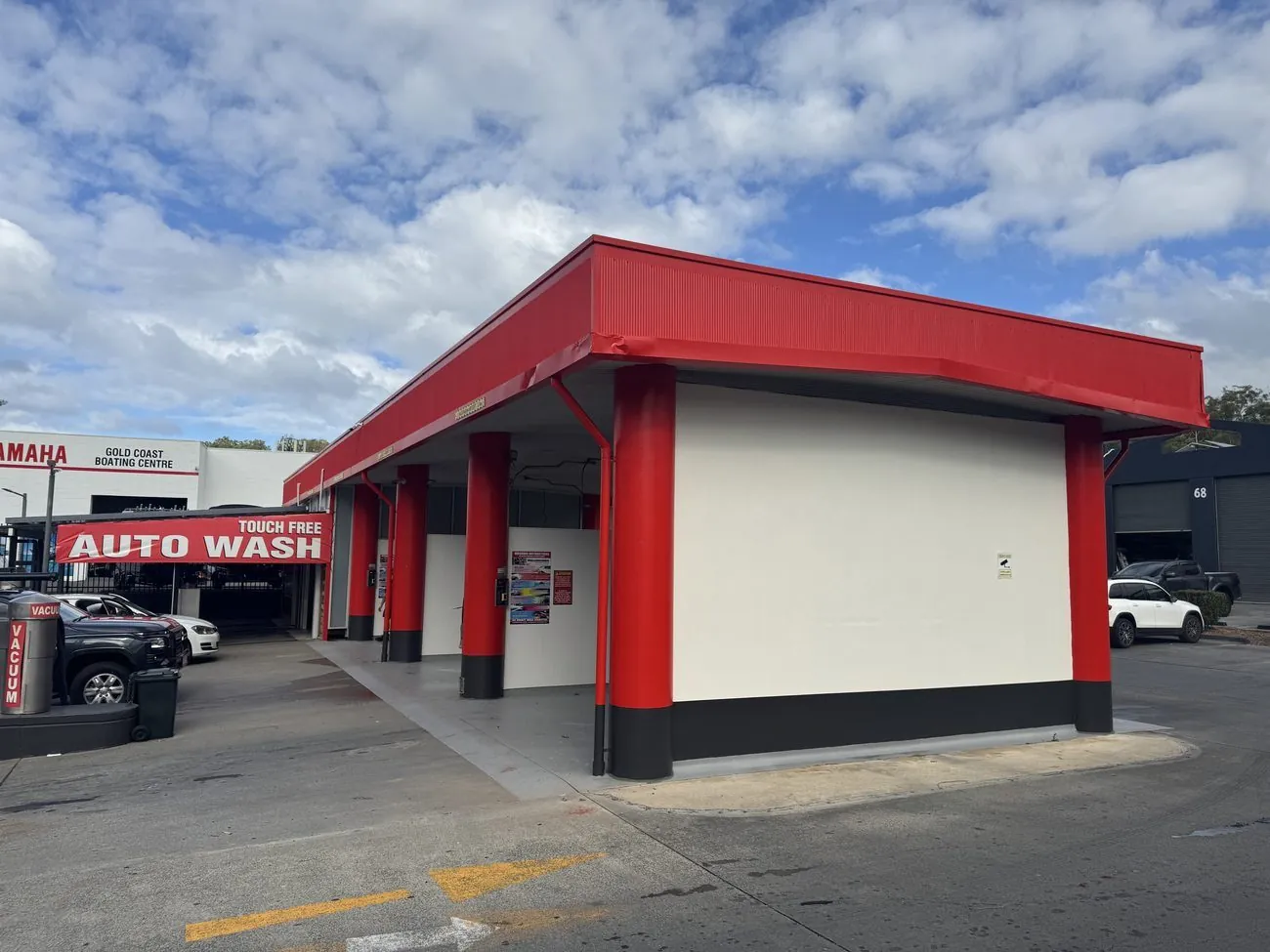 Repainted car wash with signage and wash bays at Southport