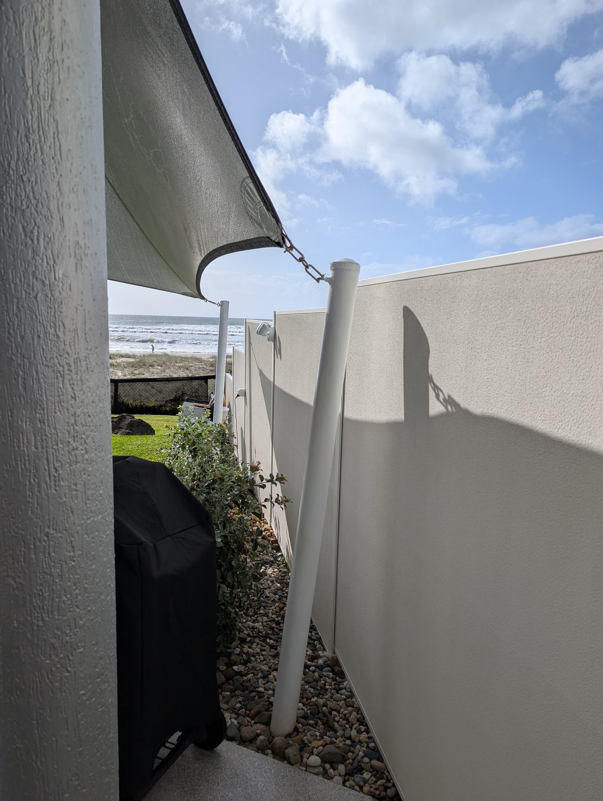Painted rendered boundary wall and walkway at Mermaid Beach