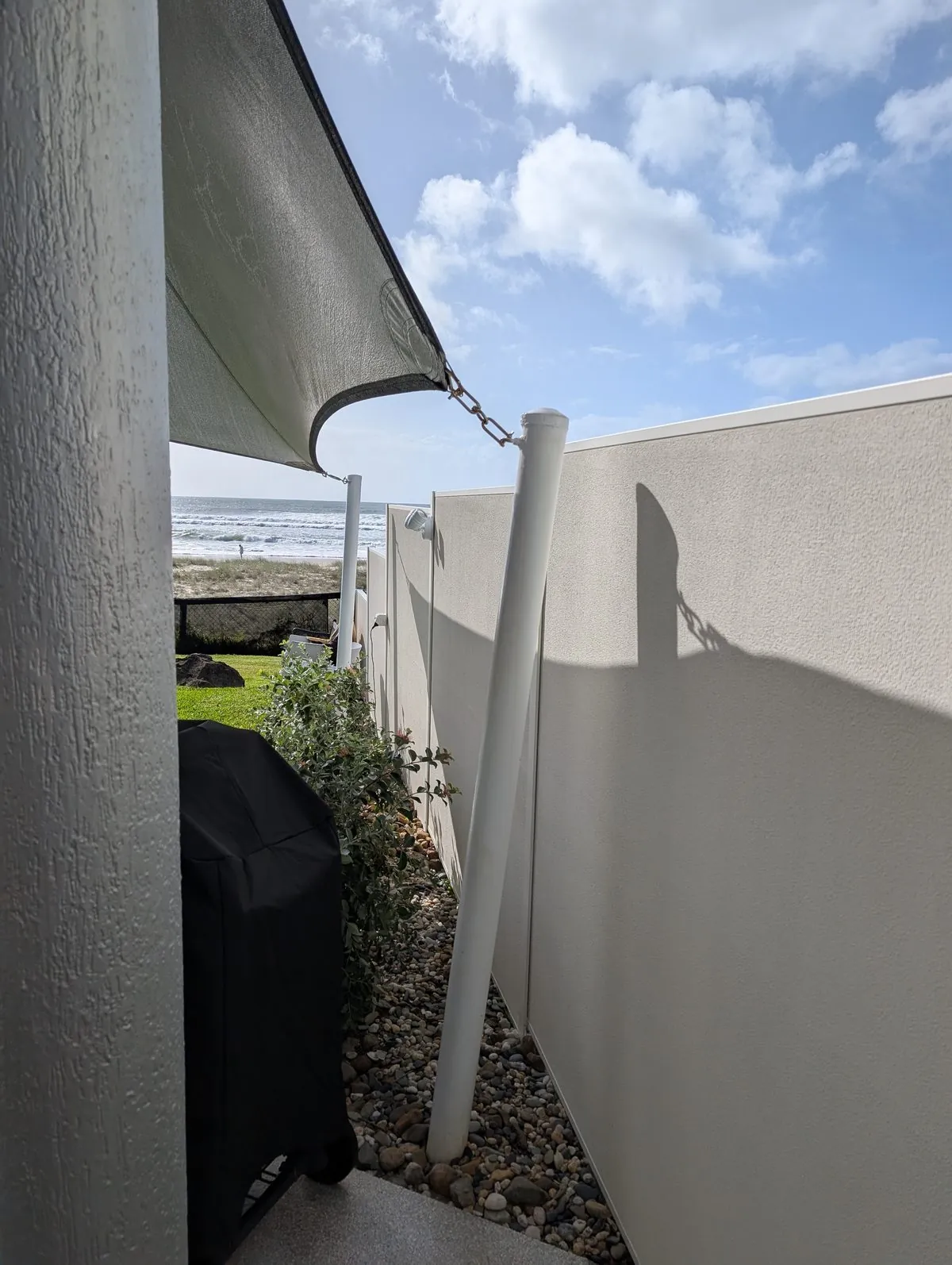 Painted rendered boundary wall and walkway at Mermaid Beach